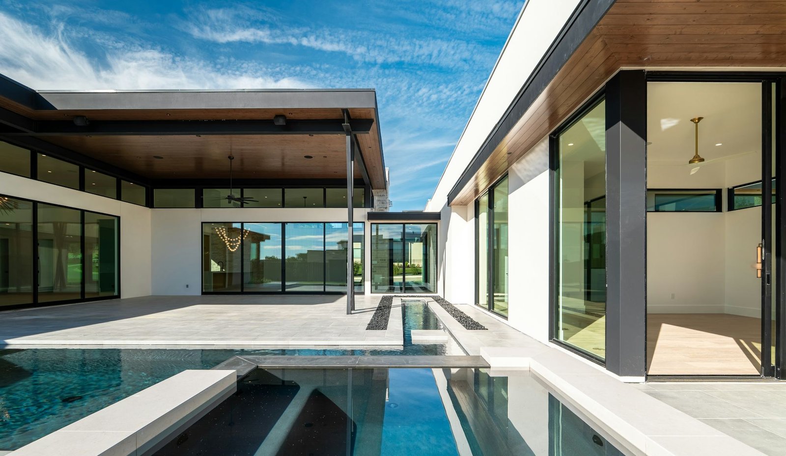 Slim-profile aluminium bi-folding doors opening onto a terrace